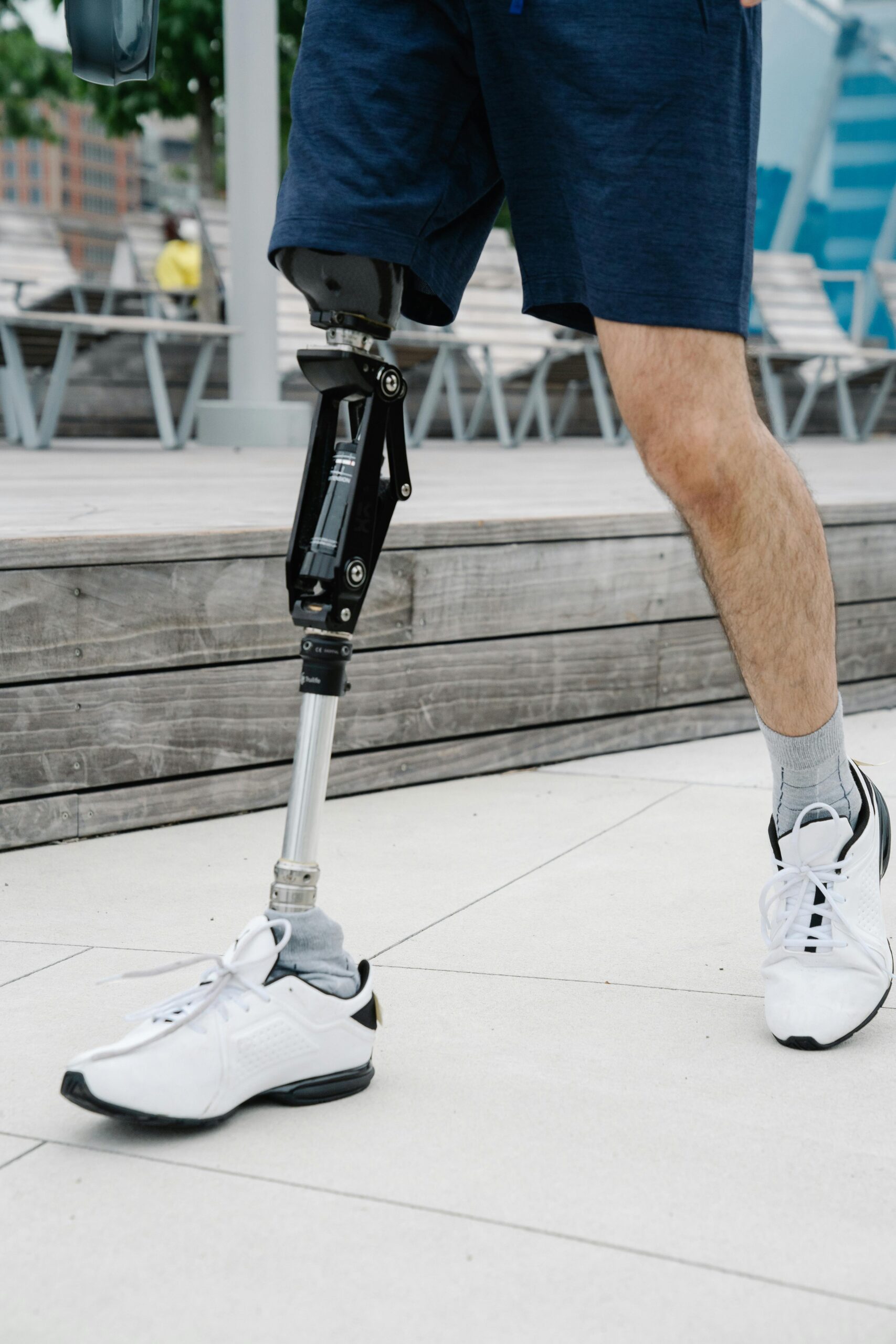 Close-up of a man walking with a prosthetic leg, promoting body positivity.